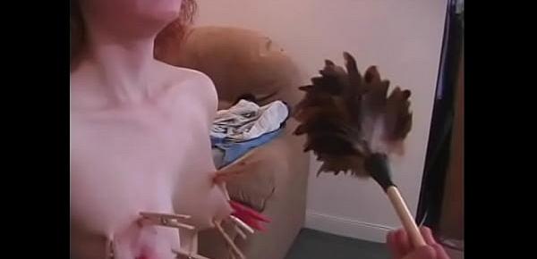  An experienced dude ties up a red-haired whore and hangs clothespins on her tits